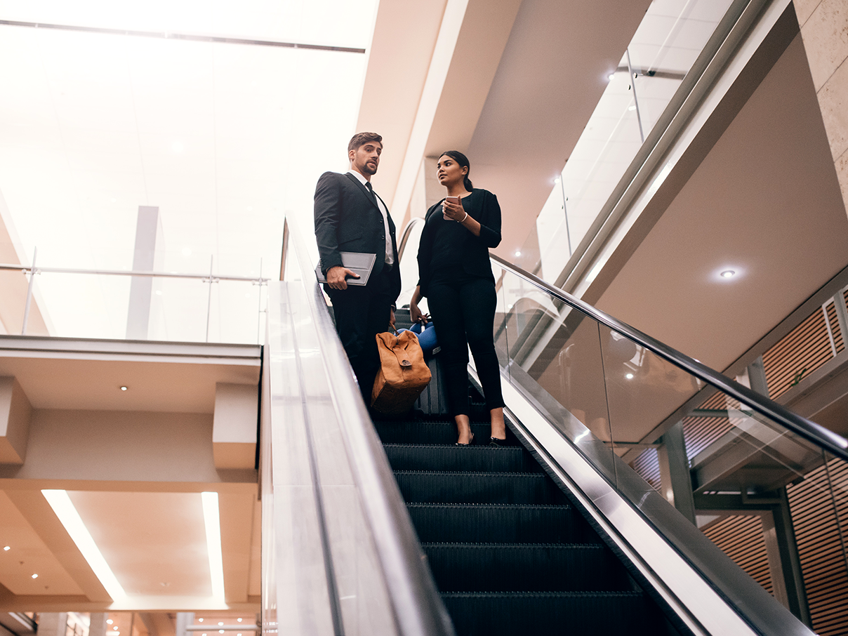 Business professionals on escalator _ Small Image