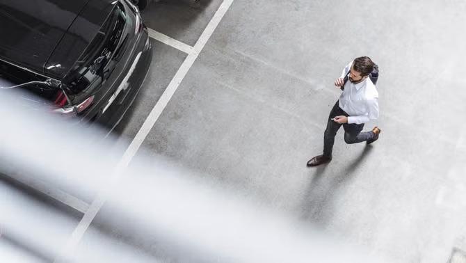 Man walking in a parking garage highlighting the travel and bleisure trends among gen z
