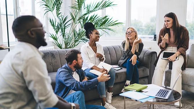 Group in a casual meeting, representing remote and hybrid workers collaborating at offsite events.
